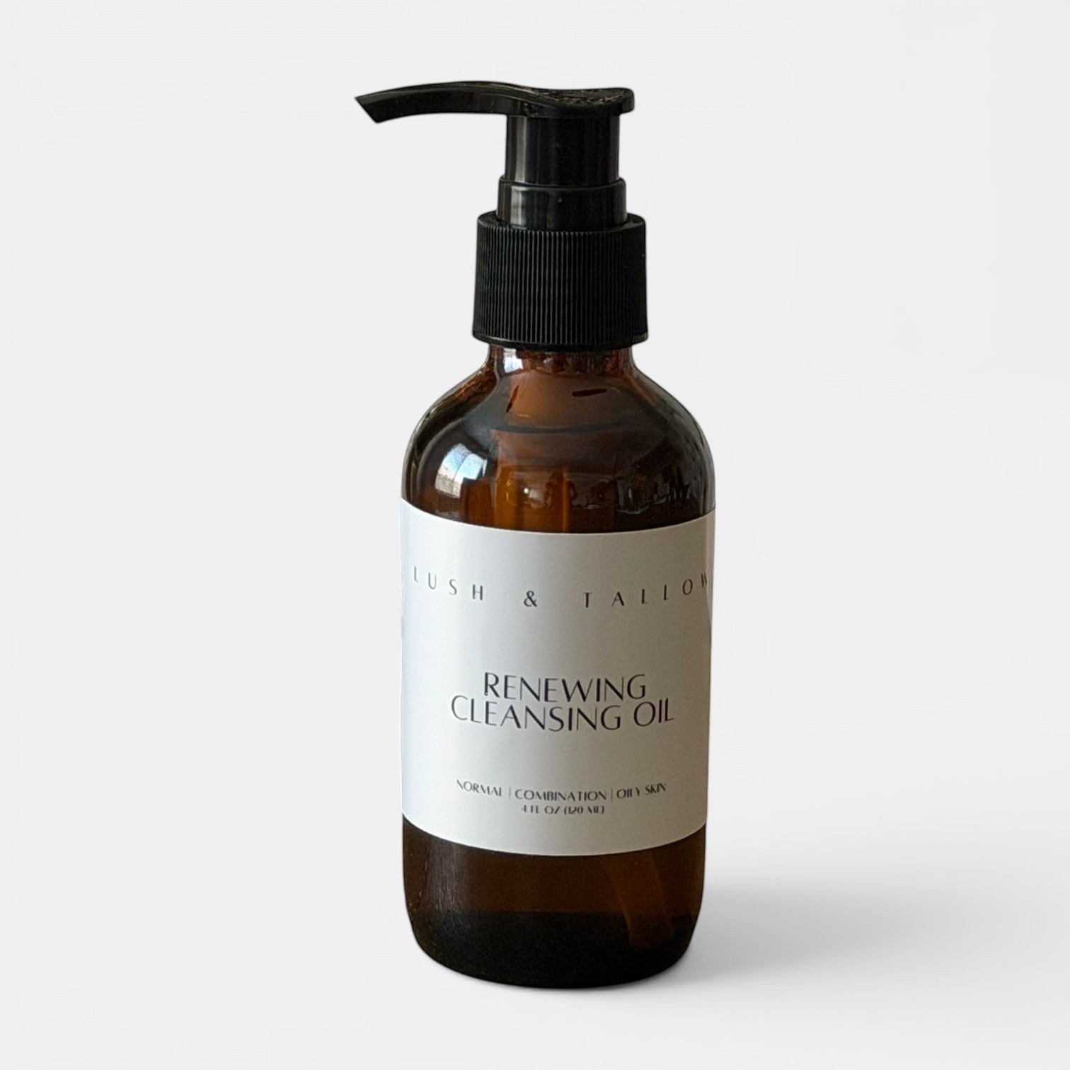 Lush & Tallow Restore & Renew Facial Cleansing Oil in an amber glass bottle with a black pump dispenser.